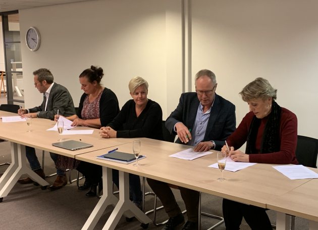 Ondertekening van het onderhandelingsresultaat met uiterst rechts voorzitter van de ActiZ-onderhandelingsdelegatie, Trudy Prins.