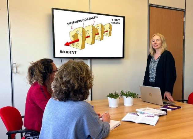 Drie mensen in een vergaderkamer